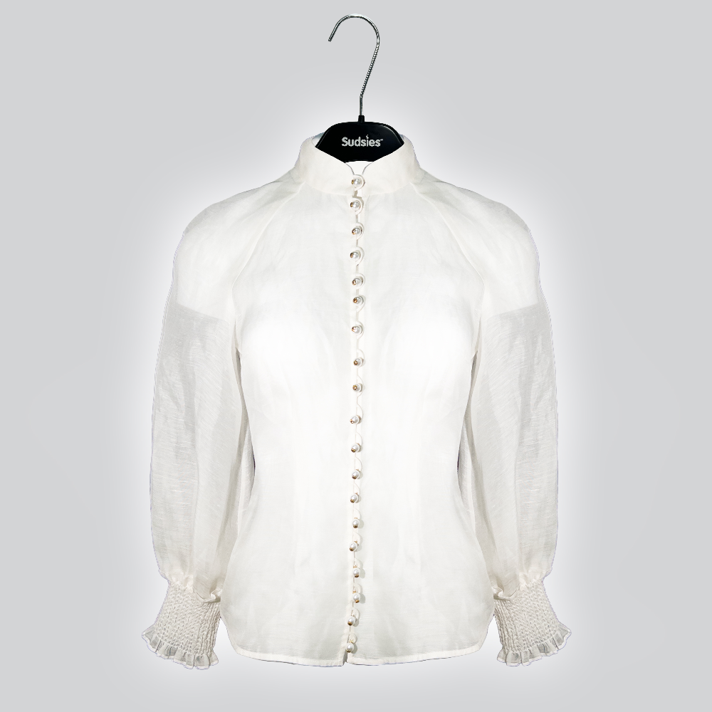 Sheer white blouse with pearl buttons on Sudsies hanger